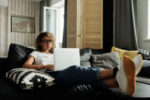 woman sitting on couch on computer