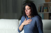 Woman holding her chest