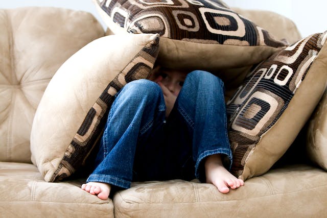 someone hiding under pillows