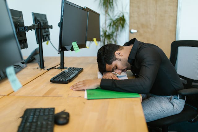 man asleep at his computer