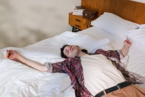 man stretched out on bed