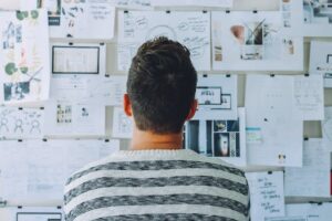 man looking at bulletin board