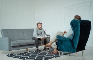 man speaking with therapist