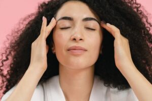 woman tapping temple accupressure point